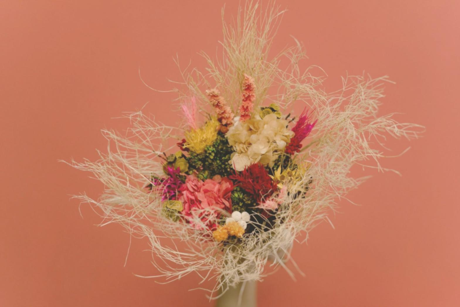 Professional florist creating elegant arrangements on-site at an event venue